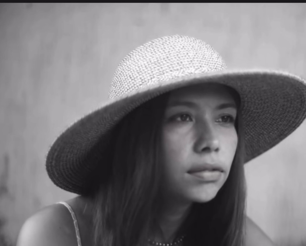 The Burial of the Dead — Dalma Daniela in a wide-brimmed hat